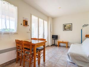 a dining room with a table and chairs and a bed at Holiday Home Les Mimosanes-5 by Interhome in Bormes-les-Mimosas