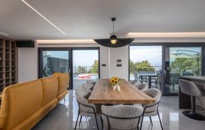 a dining room with a wooden table and chairs at Villa Aris by Villas Guide in Urinj