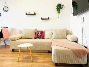 a living room with a couch and a stool at Studio Full Kitchen AC Free Parking Popcorn Wine in Chiajna