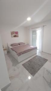Postel nebo postele na pokoji v ubytování Apartmani Miletić