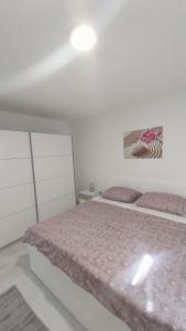 Postel nebo postele na pokoji v ubytování Apartmani Miletić