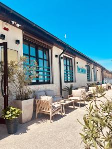 a building with a bunch of chairs and a building at La Vista by Ronda in Eforie Sud