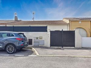 a car parked in a parking lot in front of a house at Holiday Home Maison Valoma by Interhome in Lunel