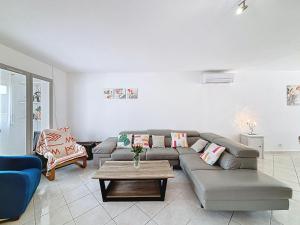 a living room with a couch and a table at Holiday Home Maison Valoma by Interhome in Lunel +32 photos