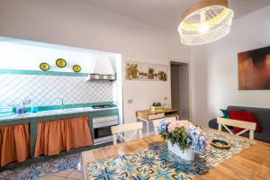 a kitchen and a living room with a table at A Casa Di Aurora Apartments in San Vito lo Capo +34 photos