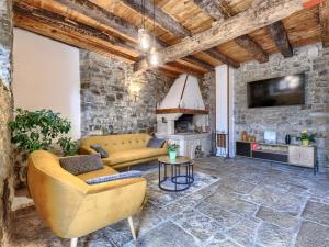 a living room with a couch and a fireplace at Holiday Home Villa Letizia by Interhome in Oprtalj