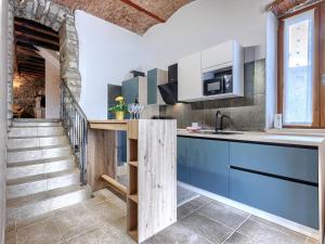 a kitchen with blue cabinets and a staircase at Holiday Home Villa Letizia by Interhome in Oprtalj +26 photos
