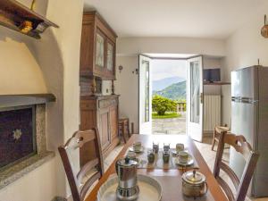 a kitchen with a table with chairs and a refrigerator at Holiday Home Bienna Antica by Interhome in Verbania