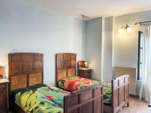 a bedroom with two beds and two dressers at Apartment Cà Maria-2 by Interhome in Asti