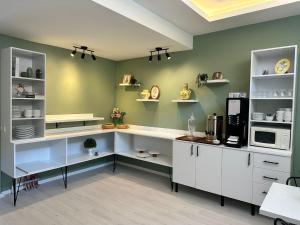 a kitchen with white cabinets and white shelves at Rinascente in Edirne