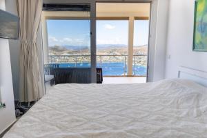 a bedroom with a bed and a view of the ocean at Stunning Sea View Cosy Apartment in Gundogan +27 photos