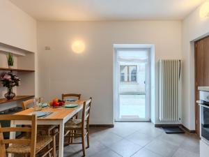 a kitchen and dining room with a table and chairs at Apartment Tre Laghi by Interhome in Carlazzo +22 photos