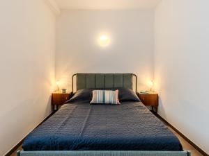 a bedroom with a blue bed with two night stands at Apartment Tre Laghi by Interhome in Carlazzo
