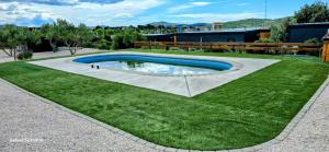 a swimming pool in the middle of a grass field at Sak Mobile Home Pirovac III in Pirovac