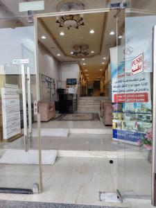 an empty lobby of a store with a sign in the foreground at العييري للشقق المخدومة النعيرية 4 in Al Nairyah