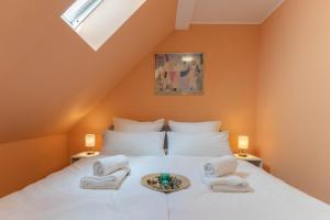 a bedroom with a bed with towels on it at Comfy Apartment Köln in Cologne