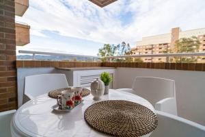 a white table and chairs on a balcony at Apartamento en Magic World in Oropesa del Mar