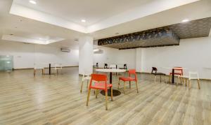 an empty room with tables and chairs in a building at Treebo The Kings Plaza in New Delhi