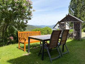 a table and two chairs sitting next to a bench at Schwarzwald Residenz - Villa Hubertus in Feldberg