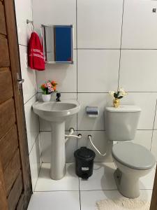 a white bathroom with a toilet and a sink at Pousada Dona Dulce in Barreirinhas +38 photos