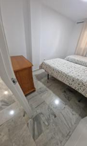 a room with a bench and a wooden table at Castillo Apartament in Torremolinos