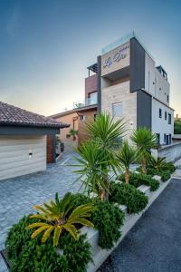a building with a bunch of plants in front of it at Luxury Rooms LaVie - Superior Rooms in Zadar