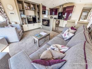 a living room with a couch and a table at Sea views at Serenity! in Truro