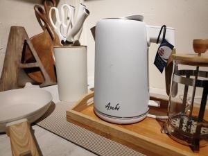 a table with two white containers of utensils at Fika Siargao - Cozy Island Home in General Luna in General Luna