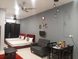 a living room with a bed and a chair at Family Studio Homestay Core Soho Kip Sentral Near KLIA & KLIA2 in Sepang