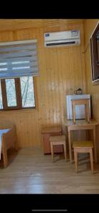 a room with benches and a table and a window at Nohurçay Cottages & Restaurant in Gabala +37 photos