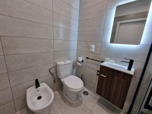 a bathroom with a toilet and a sink at Cascais Family Studio in Cascais
