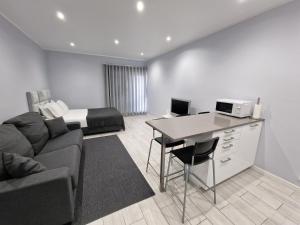 a living room with a couch and a bed at Cascais Family Studio in Cascais