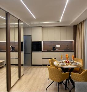 a kitchen and dining room with a table and chairs at The Modern Nest Apartment with FREE Underground Parking in Plovdiv