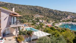 a villa with a view of the water at Coastal Paradise Found - Komis' Private Pool Retreat in Agios Nikolaos