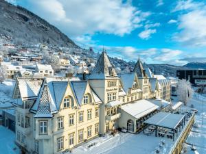 an aerial view of a large yellow building in the snow at Fleischer's Hotel in Vossevangen
