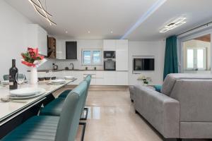 a kitchen and living room with a table and a couch at Villa Chivas ZadarVillas in Donje Raštane +27 photos