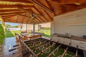 a kitchen with a ping pong game on a table at Villa Sami ZadarVillas in Pristeg