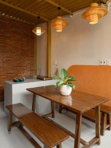a kitchen with a wooden table and a bench and a table at Kim Quý Home in Phu Quoc +28 photos