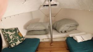a small room with two pillows on a bed at Racing Boat in Lisbon