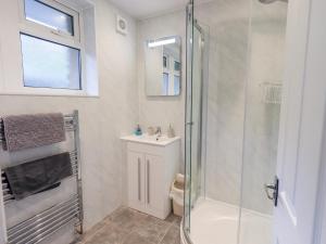 a bathroom with a shower and a sink at Rock Cottage in Keswick +11 photos