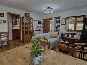 a living room with a couch and a table at Habitaciones - La Pumarada de Limés I in Cangas del Narcea