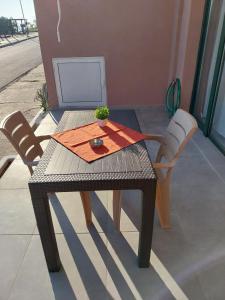 a table with two chairs and a computer on it at Villa Atspas studios in Skala Marion +47 photos