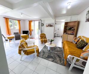 a living room with a couch and a table at Villa plaisir de vivre in Petit-Bourg