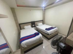 Postel nebo postele na pokoji v ubytování Hotel Ruskin PvtLtd