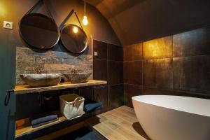 a bathroom with a large tub and two mirrors at Villa - Détente & Jacuzzi aux portes de Gérardmer in Anould +148 photos