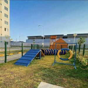 a playground with a row of slides in a park at Ap 2 quartos ,condomínio mirante clube in Fortaleza