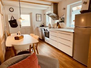 a kitchen with a table and a kitchen with a refrigerator at Altstadtglück Seligenstadt in Seligenstadt +16 photos