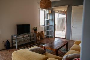 a living room with a couch and a television at El Sitio Penthouse in Playa Venao