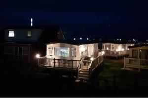 a row of houses at night with lights at Purple Palace 3-Bed Caravan Ingoldmells in Ingoldmells