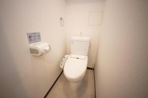 a bathroom with a white toilet in a stall at goom Monthly Nakasu JOJO in Fukuoka